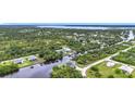 An elevated view of the home surrounded by a canal and tropical greenery at 576 Mcdill Dr, Port Charlotte, FL 33953