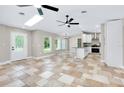 Bright living area boasts tile floors, skylight, ceiling fans, and open access to the kitchen at 875 Bayshore Dr, Englewood, FL 34223