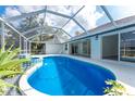 Relaxing screened-in pool area with a spa and outdoor access, perfect for entertaining and leisure at 10055 Franklin Dr, Englewood, FL 34224