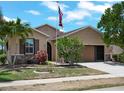 Well-maintained single-Gathering home with lush front yard, mature landscaping, and an American flag at 10131 Winding River Rd, Punta Gorda, FL 33950