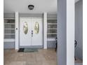 Inviting front entryway featuring double doors, neutral tile, and light gray accents at 123 Annapolis Ln, Rotonda West, FL 33947