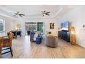 Spacious living room featuring a ceiling fan, stylish decor, and seamless access to the screened lanai and pool at 14684 Cherry Blossom Way, Punta Gorda, FL 33955