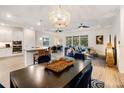 Open-concept living space featuring a stylish dining area and an inviting living room with wood-look tile floors at 14684 Cherry Blossom Way, Punta Gorda, FL 33955