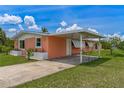 Single Gathering home featuring a covered carport, well-maintained lawn, and waterfront access at 161 Danforth Dr, Punta Gorda, FL 33980
