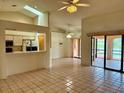Bright living room with skylights, tiled floors, an open bar, and a clear view of the kitchen at 214 Castile Ct, Punta Gorda, FL 33983