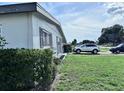 Side exterior view of house with car parked in the driveway at 22187 Lasalle Rd, Port Charlotte, FL 33952