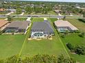 Aerial view shows the property lines, a screened pool and patio, and the surrounding neighborhood at 260 Rotonda E Blvd, Rotonda West, FL 33947
