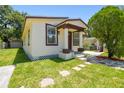 Exterior view of a home with a well-kept lawn and front porch at 2626 E 38Th Ave, Tampa, FL 33610