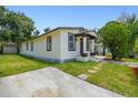 Exterior view of a home with a well-kept lawn, front porch, and off-street parking at 2626 E 38Th Ave, Tampa, FL 33610