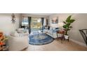 Bright living room with sliding glass doors, comfortable seating, stylish decor and tile flooring at 311 Garvin St # 301B, Punta Gorda, FL 33950