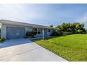Well-maintained home with an attached garage, front yard and long driveway at 3270 Ithaca St, Port Charlotte, FL 33952