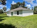 Rear exterior view of a single-story home, showcasing a well-maintained lawn and landscaping at 3532 Richardson St, North Port, FL 34288