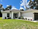 Charming single-story home featuring a well-manicured lawn and a welcoming entrance at 3532 Richardson St, North Port, FL 34288