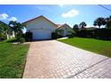 Charming single-story home with red tile roof and brick paved driveway leading to an attached garage at 3588 Tripoli Blvd, Punta Gorda, FL 33950