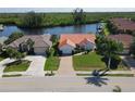 Charming waterfront home with red tile roof, brick driveway, and serene canal views at 3588 Tripoli Blvd, Punta Gorda, FL 33950