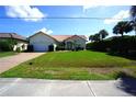 Inviting single-story home with a red tile roof, manicured lawn, and charming curb appeal at 3588 Tripoli Blvd, Punta Gorda, FL 33950