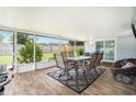 Screened-in patio with outdoor dining set and comfortable seating, perfect for enjoying the backyard view at 3612 Patina Dr, Tampa, FL 33619