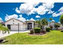 Charming single-story home features a well-manicured lawn, mature landscaping, and a convenient two-car garage at 4142 Reif Ct, Port Charlotte, FL 33981
