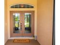 Welcoming double front doors with a 'HELLO' mat and charming decorative accents at 4640 W Price Blvd, North Port, FL 34286