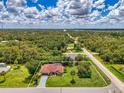 Spacious lot with mature trees featuring a single-story home, pool, and expansive green lawn at 510 Border St, Port Charlotte, FL 33953
