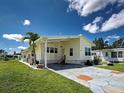 Charming single-story home featuring a covered carport and well-maintained landscaping and stone-paved driveway at 6562 Hikina Dr, North Port, FL 34287