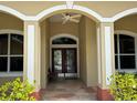 Inviting front entrance with double doors and stone pathway at 6594 Buckboard St, North Port, FL 34291