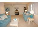 Cozy living room featuring comfortable sofas, a piano, and serene artwork at 724 Hartford Nw Dr, Port Charlotte, FL 33952