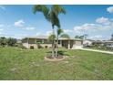 Lovely home with a well-maintained lawn, mature trees, and a paved driveway, blending comfort and style at 1107 Seneca Rd, Venice, FL 34293