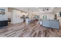 Open-concept living area with wood floors, modern furnishings, and a seamless flow to the kitchen at 12300 El Prado Dr, Punta Gorda, FL 33955