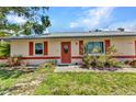 Inviting front entrance with colorful landscaping and charming curb appeal at 1242 Orlando Blvd, Port Charlotte, FL 33952
