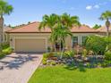 Charming single-Gathering home with a well-manicured lawn, beautiful landscaping, and a two-car garage at 13136 N Marsh Dr, Port Charlotte, FL 33953