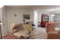 Inviting living room featuring comfortable seating, classic decor, and a view into the adjacent dining area at 1389 Hinton St, Port Charlotte, FL 33952