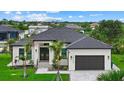 Beautiful single-story home with meticulously maintained landscaping, inviting entrance, and a two-car garage at 14166 Fort Worth Cir, Port Charlotte, FL 33981