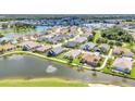 Community aerial view overlooking single-Gathering homes along a large lake with a fountain at 1617 Britannia Blvd, Punta Gorda, FL 33980