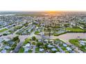 Aerial view of a waterfront community with canals, lush greenery, and beautiful homes at 180 Palmetto Ne Cir, Port Charlotte, FL 33952