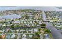 Expansive aerial view of homes along canals and waterfront properties with a bridge and nearby bay at 180 Palmetto Ne Cir, Port Charlotte, FL 33952