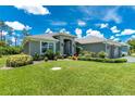 Inviting single-story home featuring a well-maintained lawn and colorful front garden at 185 Hercules Dr, Rotonda West, FL 33947
