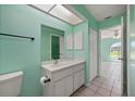 Bathroom featuring a single sink vanity and a view to the living room and window at 1865 Rival Ter, North Port, FL 34286