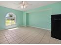 Light and airy living room with a large window and neutral tile flooring at 1865 Rival Ter, North Port, FL 34286