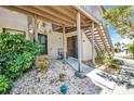 This condo features a cute front patio, adorned with stone, shrubbery and access to stairs to the upper level at 26336 Nadir Rd # 10, Punta Gorda, FL 33983
