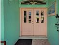 The double front door to the residence is painted pink and has vertical rectangular windows at 2969 Wells Ave, North Port, FL 34286
