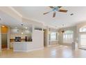 Open-concept living area with tiled flooring, neutral paint, and abundant natural light at 421 Marsh Creek Rd, Venice, FL 34292