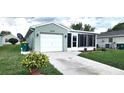 Charming one-story home featuring a one-car garage, enclosed lanai, and well-maintained lawn at 426 Ricold Ter, Port Charlotte, FL 33954
