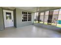 Bright Florida Room with a ceiling fan, large windows, and a door leading to the backyard at 426 Ricold Ter, Port Charlotte, FL 33954