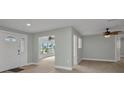 Bright living room features modern paint, fan, and wood-look flooring at 114 Sinclair Se St, Port Charlotte, FL 33952