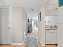 Bright foyer with hardwood floors leading to the living area and adjacent to a modern kitchen space at 1144 Bird Bay Way # 102, Venice, FL 34285