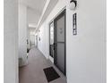 Condo hallway with a black door and the number 1144 and a black welcome mat at 1144 Bird Bay Way # 102, Venice, FL 34285