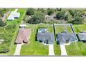 Aerial view of a residential neighborhood showcasing neatly landscaped yards and a private pool at 12112 Helios Ave, Port Charlotte, FL 33981