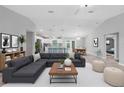 Spacious open-concept living area with modern decor and plenty of natural light, with kitchen in the background at 12112 Helios Ave, Port Charlotte, FL 33981