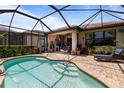 Sparkling pool with screened enclosure, brick pavers, and an outdoor lounge area at 13935 Campoleone St, Venice, FL 34293